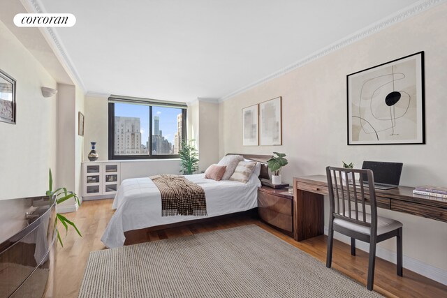 bedroom featuring light hardwood / wood-style flooring and ornamental molding