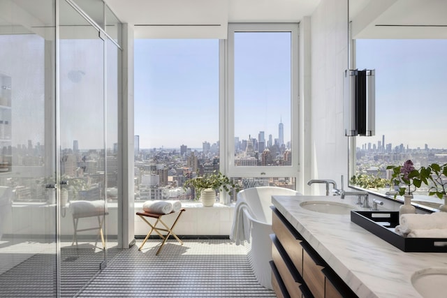 bathroom with a sink, a soaking tub, a view of city, double vanity, and a stall shower