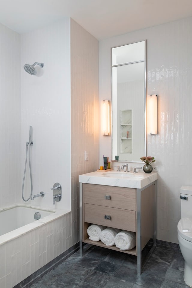 full bathroom with tiled shower / bath combo, vanity, and toilet