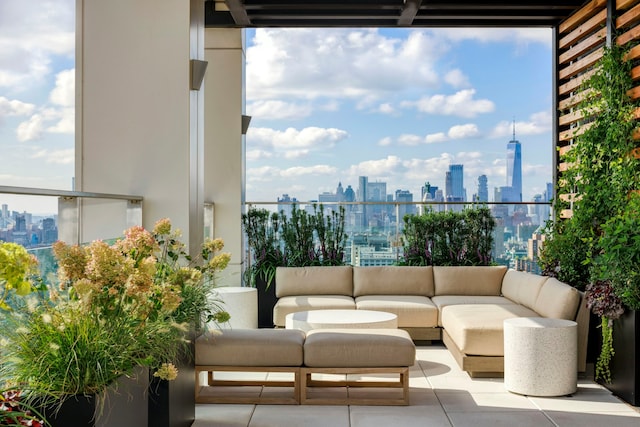 balcony with an outdoor living space, a city view, and a patio