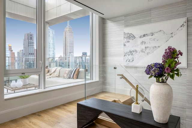 office area with plenty of natural light, wood finished floors, and a city view