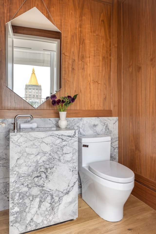 bathroom featuring wood finished floors and toilet