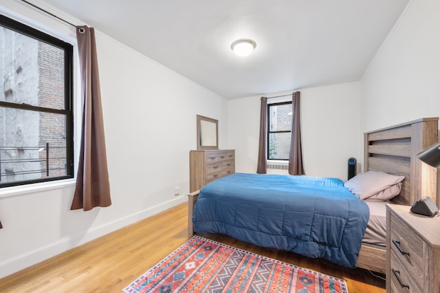 bedroom with hardwood / wood-style flooring