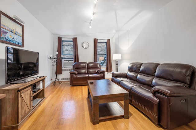 living room with cooling unit, light hardwood / wood-style flooring, and track lighting