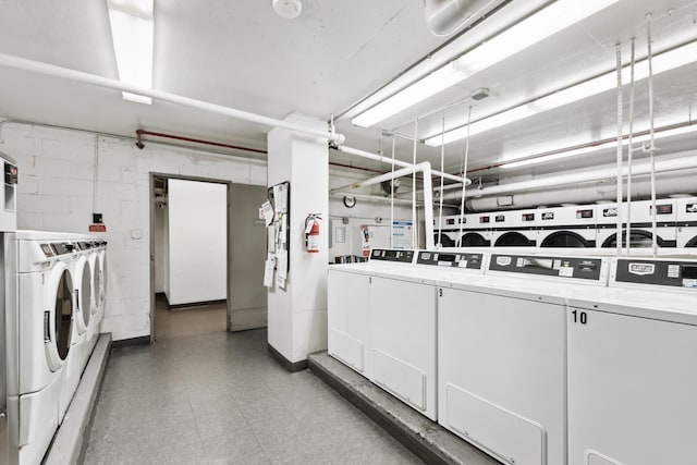 common laundry area with washing machine and clothes dryer and tile patterned floors