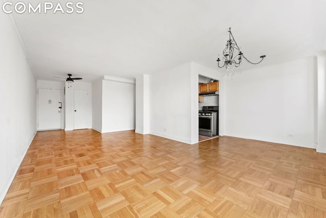 unfurnished living room with ceiling fan with notable chandelier, light parquet floors, and crown molding