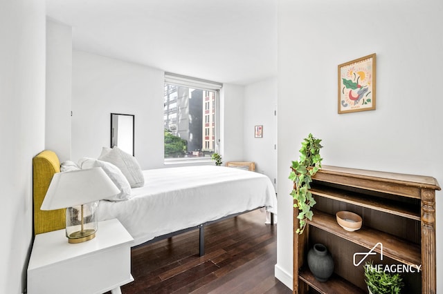 bedroom with dark wood-style flooring