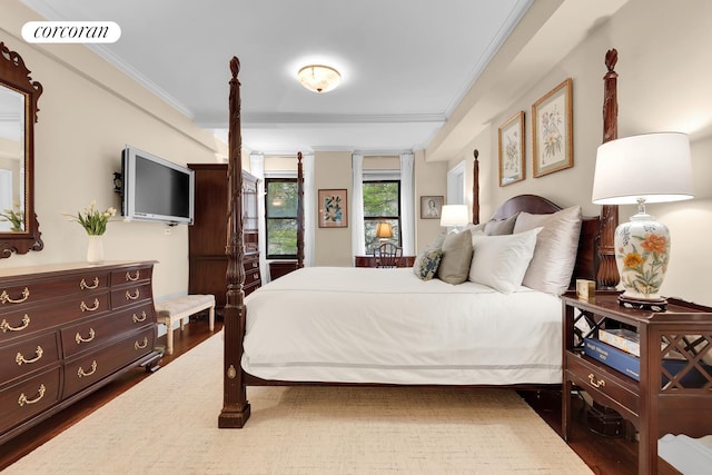 bedroom featuring ornamental molding, wood finished floors, and visible vents