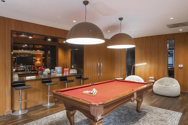 playroom with indoor wet bar, wooden walls, wood finished floors, and visible vents