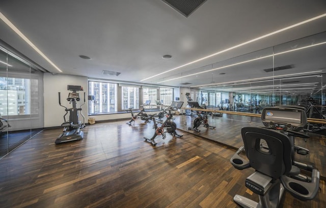 workout area with visible vents and wood finished floors