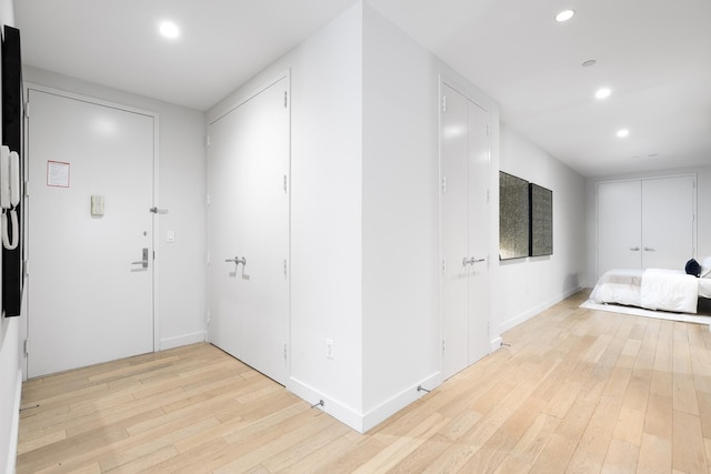 75 Wall St Unit 26A, New York City, NY 10005 - corridor with light wood-style flooring, recessed lighting, and baseboards