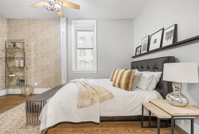 bedroom featuring ceiling fan and dark hardwood / wood-style floors