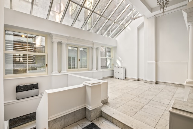 sunroom with decorative columns and heating unit