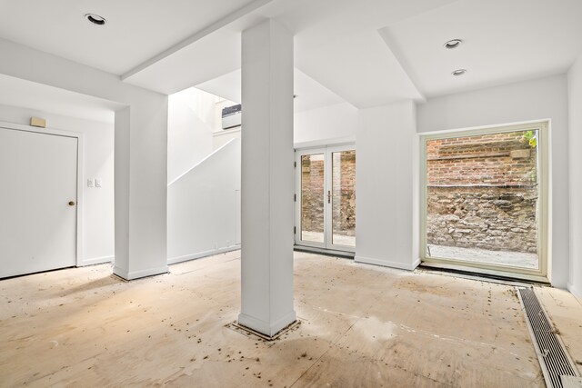 entryway featuring a healthy amount of sunlight and a wall unit AC