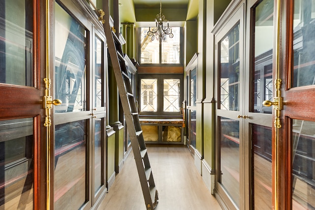 31 Greene St Unit 1, New York City, NY 10013 - unfurnished sunroom featuring french doors, a chandelier, and plenty of natural light