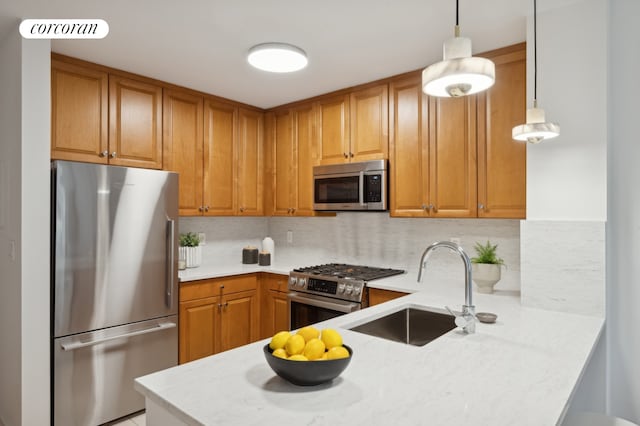 425 Main St Unit 14A, New York City, NY 10044 - kitchen featuring appliances with stainless steel finishes, a peninsula, backsplash, and brown cabinetry