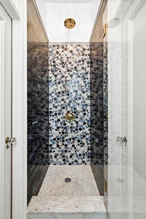 bathroom with tiled shower