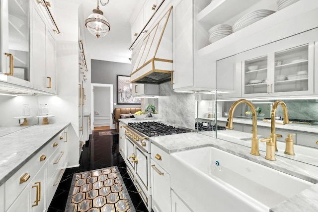 kitchen featuring white cabinets, light stone countertops, and sink