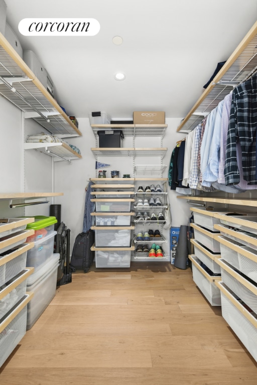 spacious closet featuring hardwood / wood-style flooring