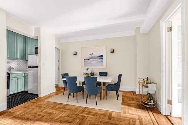 49 W 72nd St Unit 6E, New York City, NY 10023 - dining space featuring light parquet flooring, sink, and beam ceiling