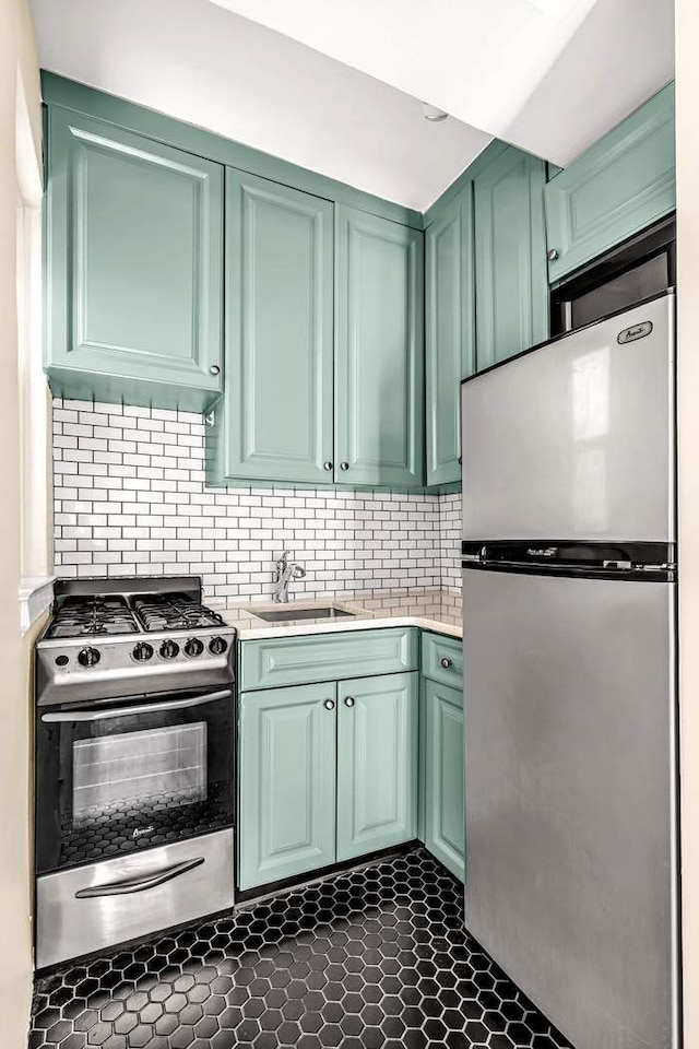 49 W 72nd St Unit 6E, New York City, NY 10023 - kitchen with green cabinets, stainless steel appliances, and sink
