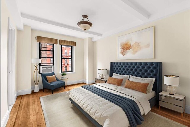 bedroom with wood-type flooring, cooling unit, and beamed ceiling