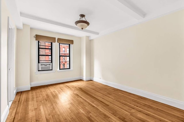 49 W 72nd St Unit 6E, New York City, NY 10023 - spare room featuring cooling unit, wood-type flooring, and beamed ceiling