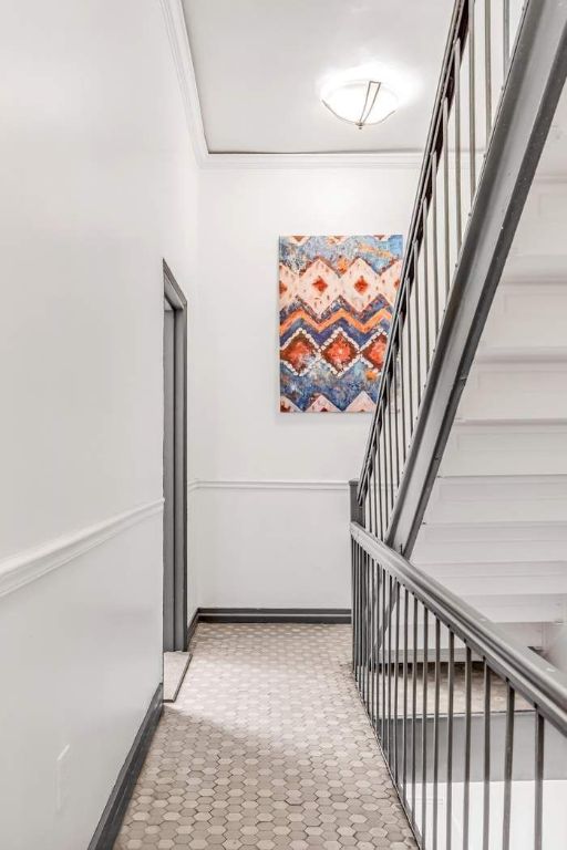 corridor featuring ornamental molding