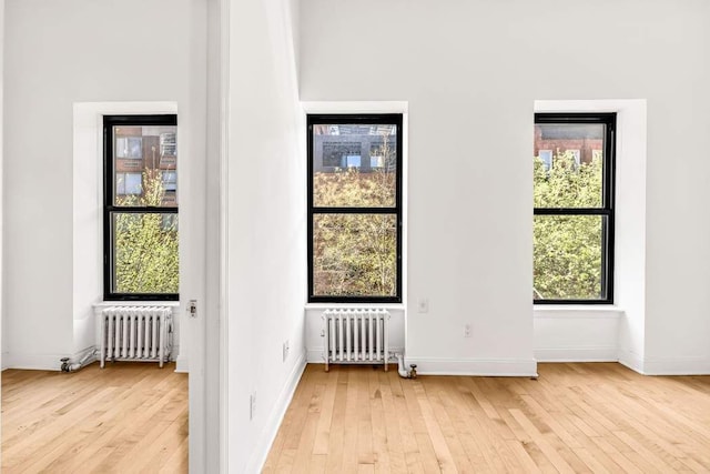 doorway to outside featuring radiator heating unit and light wood-type flooring