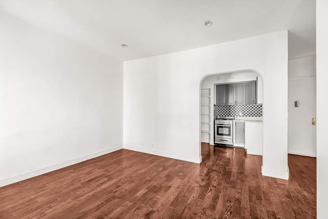 unfurnished living room featuring dark hardwood / wood-style flooring