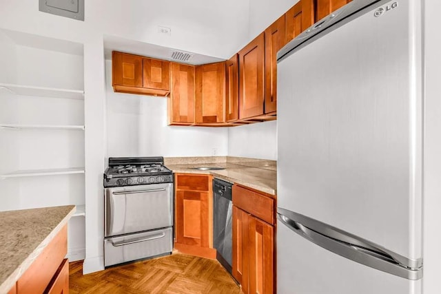 kitchen with light parquet floors and appliances with stainless steel finishes