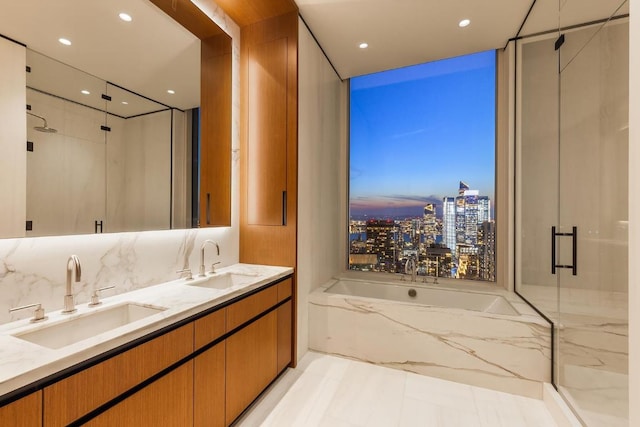 bathroom featuring vanity and separate shower and tub