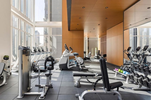 exercise room with expansive windows, a wealth of natural light, and wooden ceiling