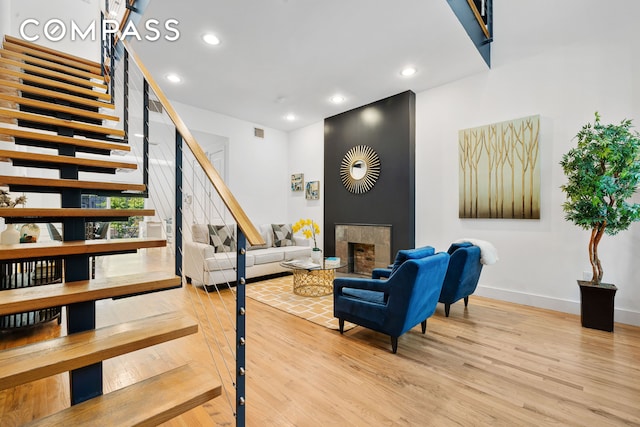 160 W 128th St, New York City, NY 10027 - living room featuring stairs, wood finished floors, a fireplace, and recessed lighting