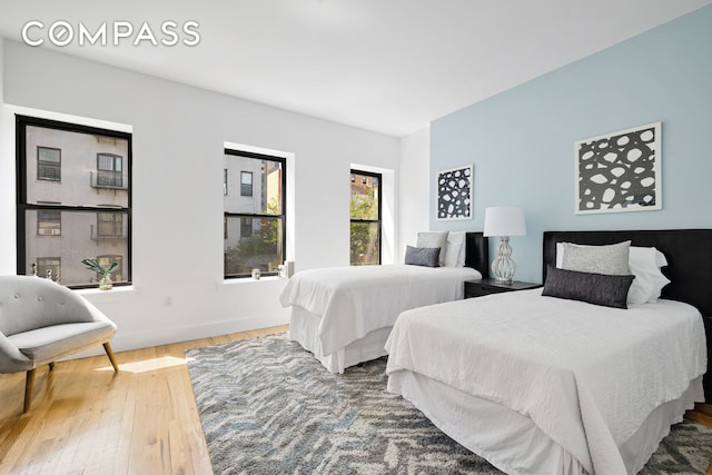 bedroom featuring hardwood / wood-style flooring and baseboards