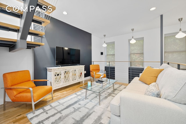 living area featuring a wainscoted wall, wood finished floors, and recessed lighting