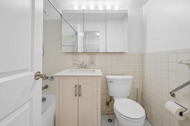 full bathroom featuring toilet, tile walls, vanity, and shower / bath combo with shower curtain