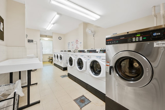 laundry room featuring light tile patterned floors and washer and dryer