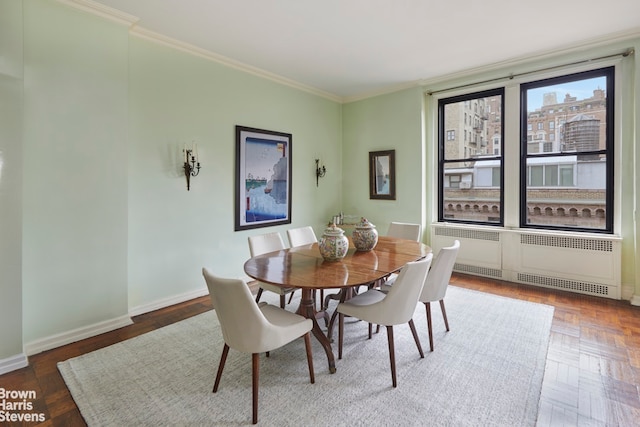 dining room featuring parquet flooring, radiator, and ornamental molding