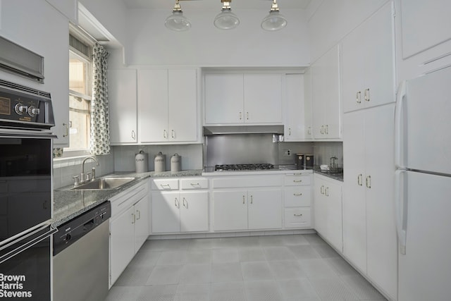 kitchen with white cabinets, decorative backsplash, appliances with stainless steel finishes, and sink