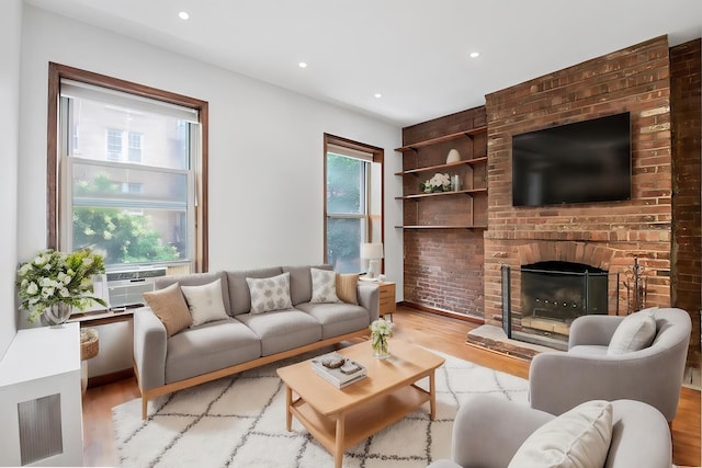 living room featuring recessed lighting, cooling unit, wood finished floors, and a fireplace