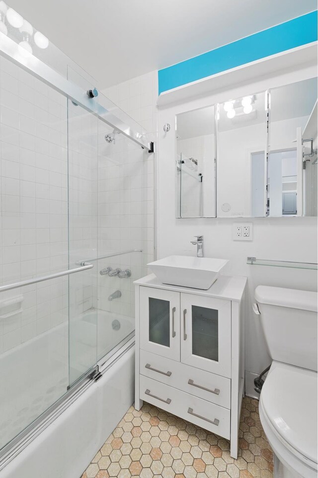 146 W 82nd St Unit 3A, New York City, NY 10024 - full bath with combined bath / shower with glass door, toilet, vanity, and tile patterned flooring