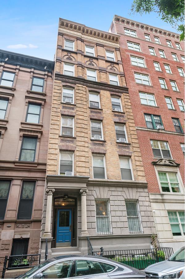 146 W 82nd St Unit 3A, New York City, NY 10024 - living area with wood finished floors, cooling unit, recessed lighting, and a brick fireplace