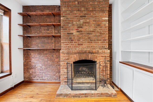 146 W 82nd St Unit 3A, New York City, NY 10024 - detailed view of baseboards, wood finished floors, and a brick fireplace