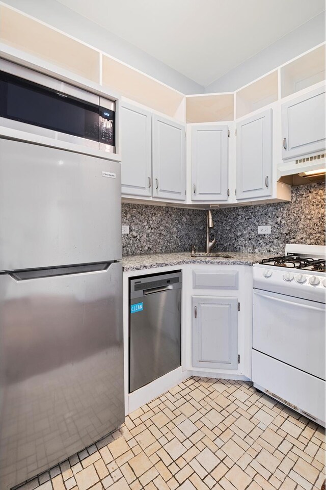 146 W 82nd St Unit 3A, New York City, NY 10024 - kitchen featuring appliances with stainless steel finishes, ventilation hood, a sink, tasteful backsplash, and white cabinetry