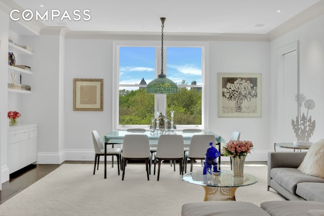 dining room with baseboards, dark wood-style flooring, and crown molding