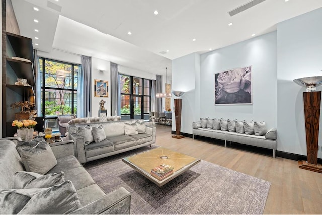 living room with hardwood / wood-style flooring and a notable chandelier