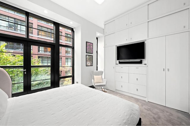 bedroom with light colored carpet and french doors