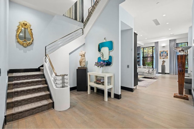 stairs with hardwood / wood-style flooring