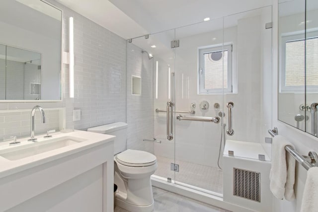 bathroom with toilet, backsplash, tile walls, walk in shower, and vanity